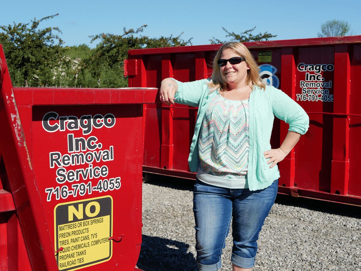 Cragco office team member with a dumpster